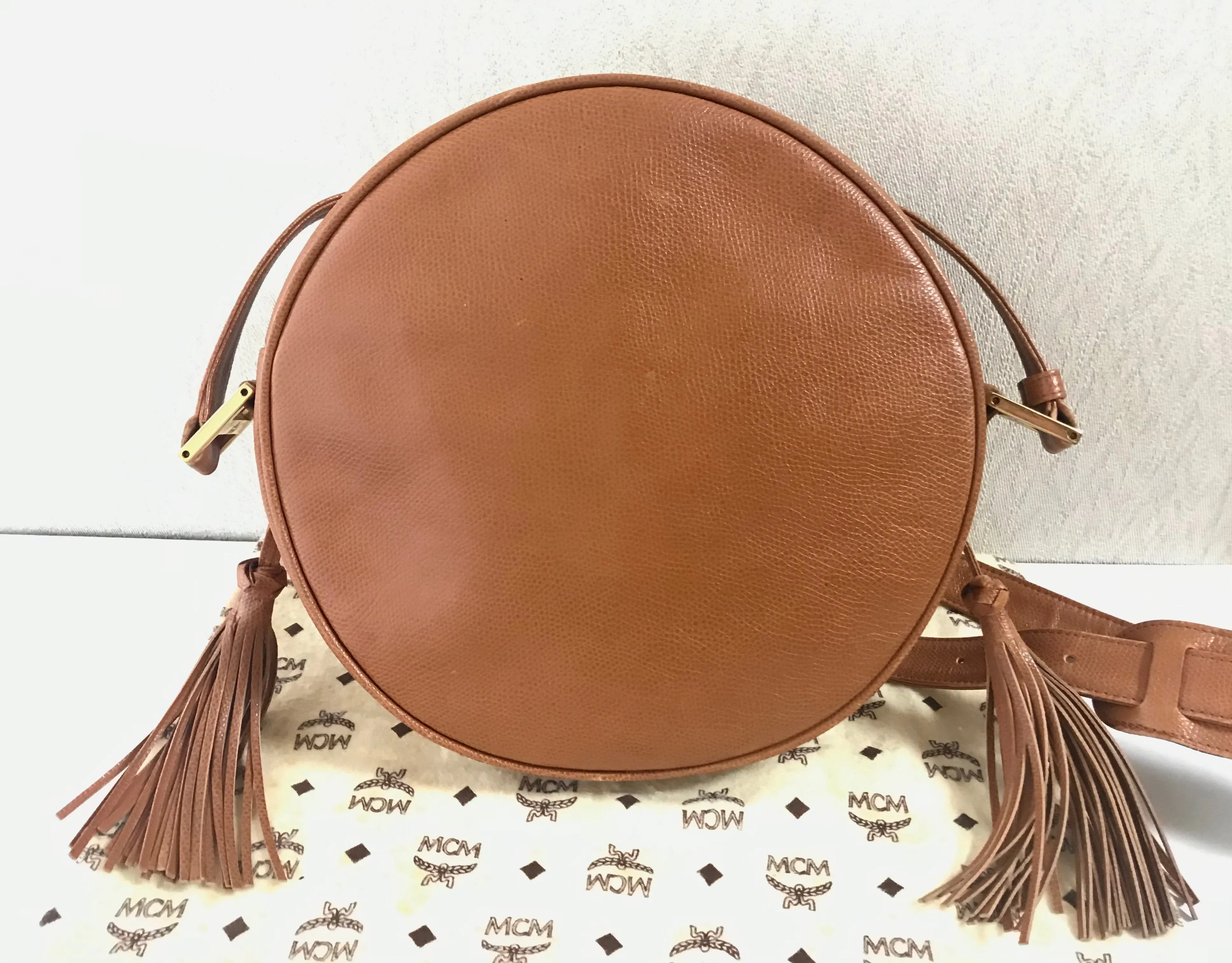 Vintage MCM suzy wong bag, brown grained leather round shoulder bag with studs and fringes. Designed by Michael Cromer. Nature. 060531r8