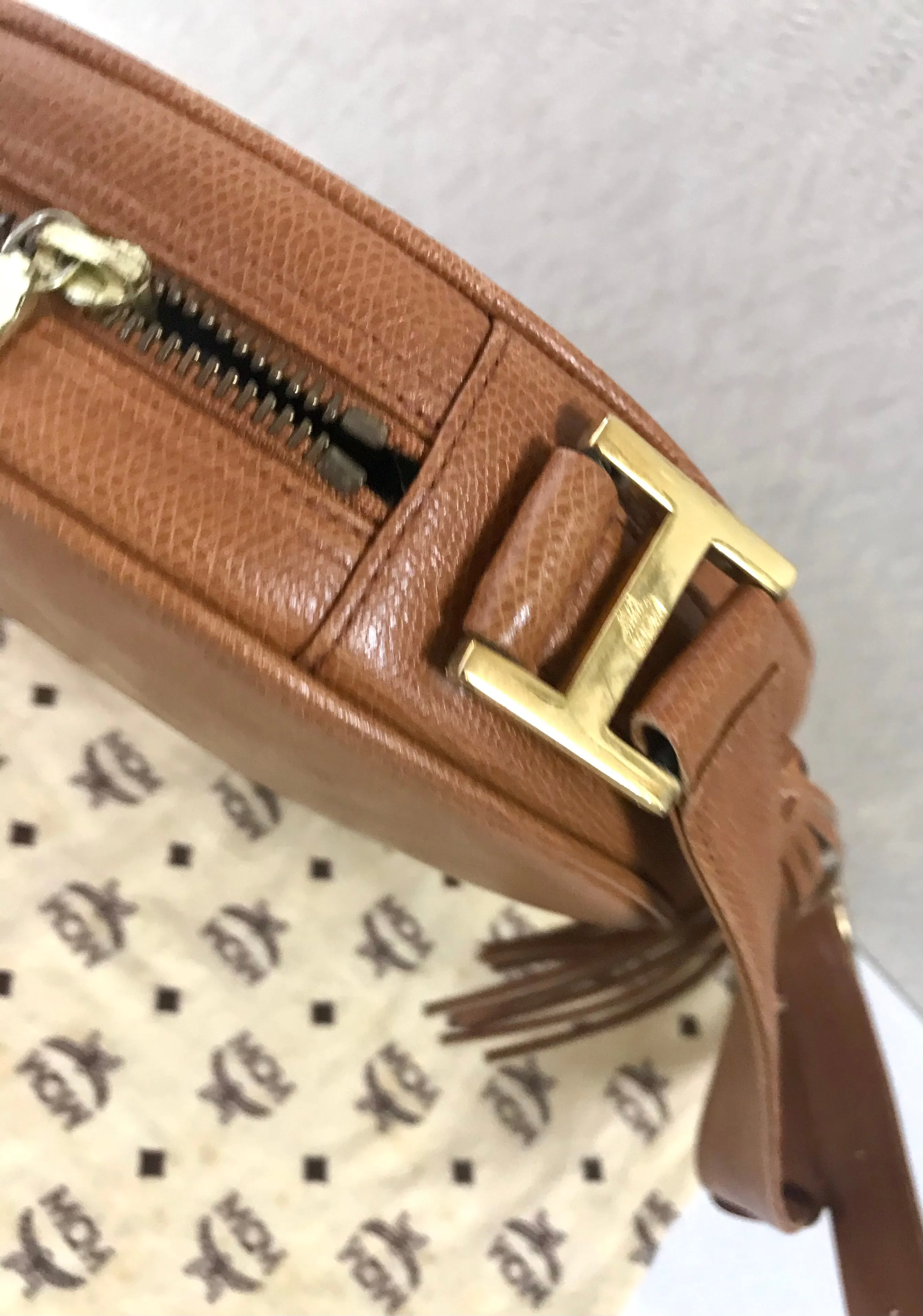 Vintage MCM suzy wong bag, brown grained leather round shoulder bag with studs and fringes. Designed by Michael Cromer. Nature. 060531r8