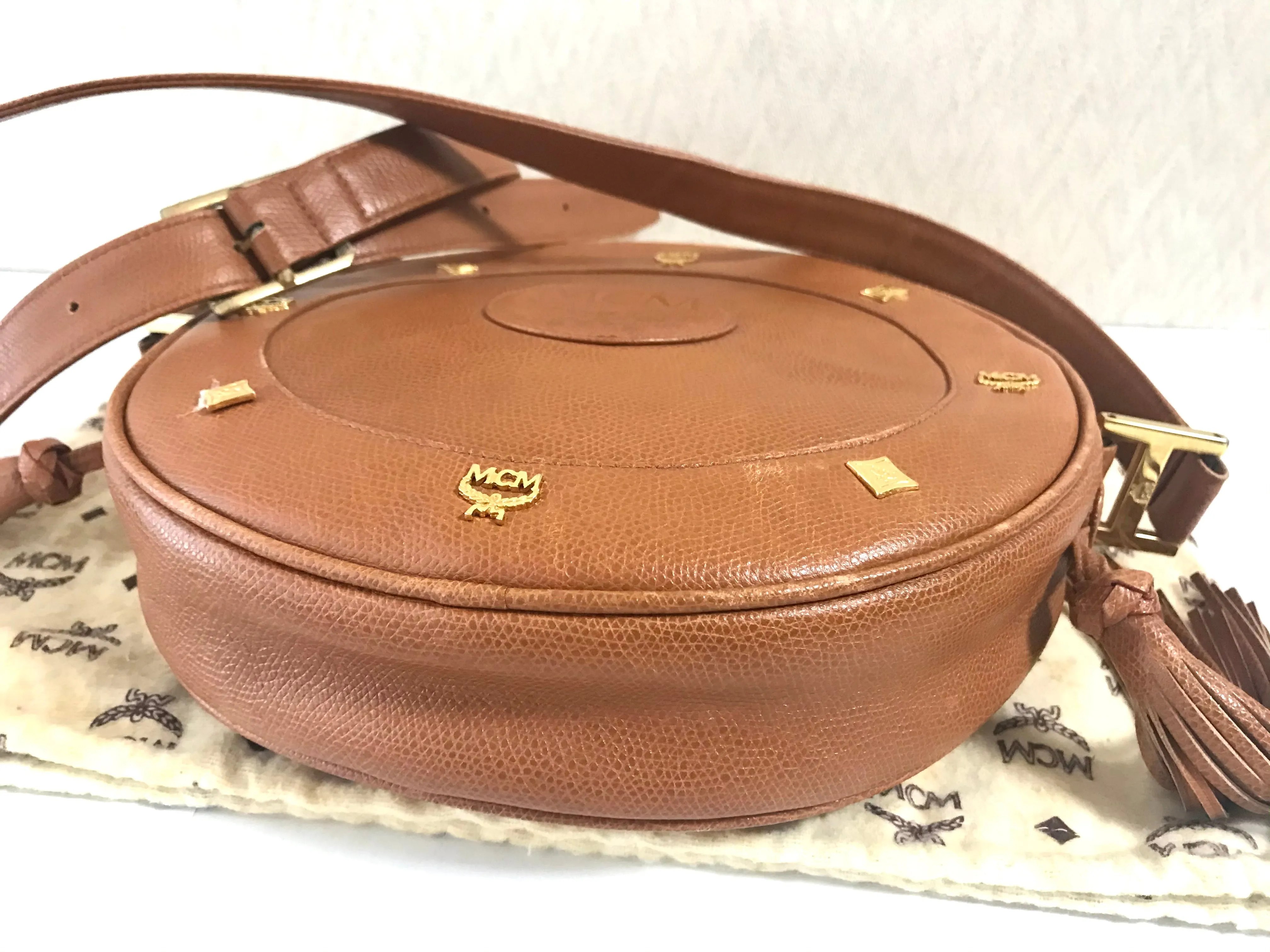 Vintage MCM suzy wong bag, brown grained leather round shoulder bag with studs and fringes. Designed by Michael Cromer. Nature. 060531r8