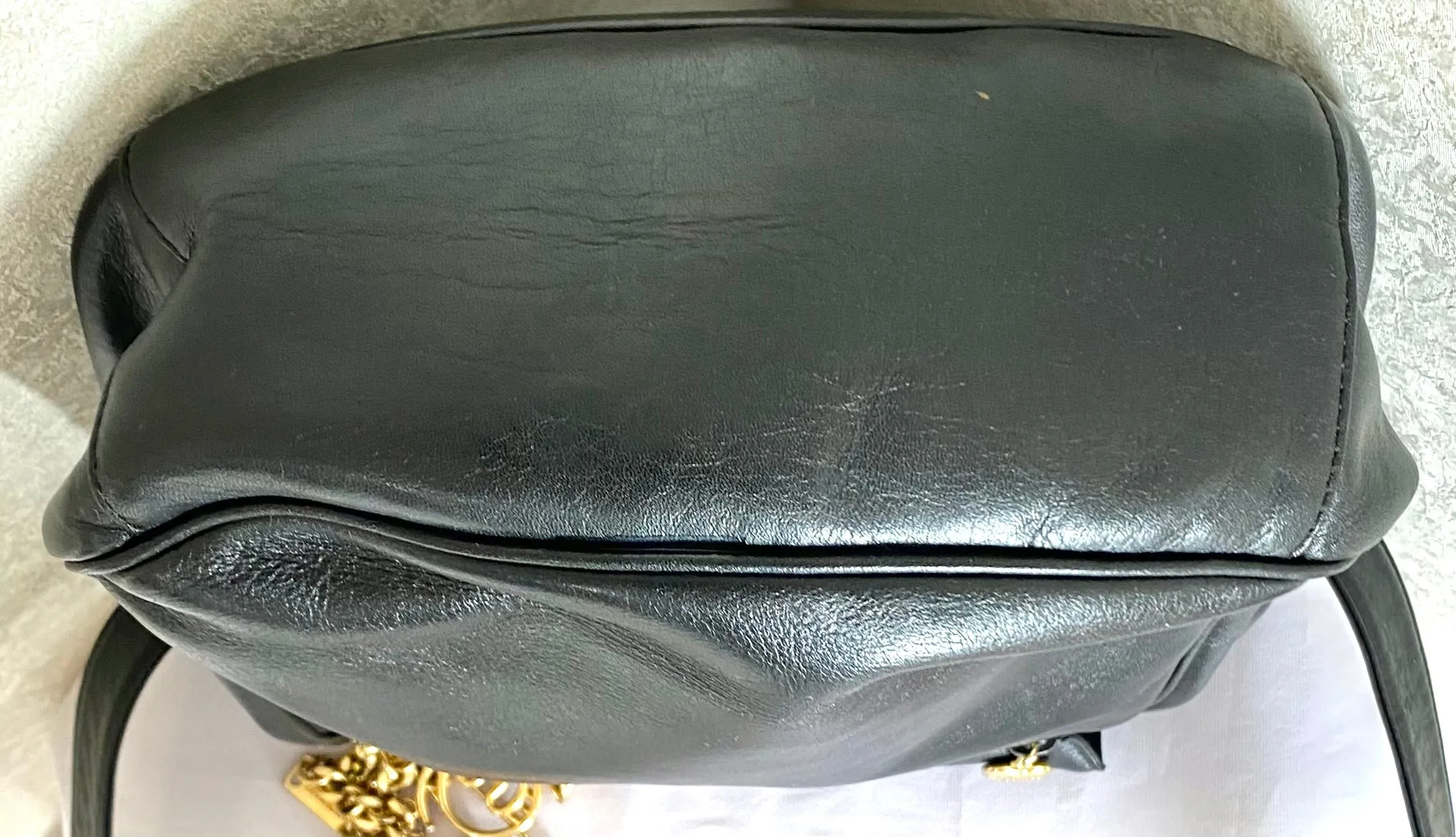Vintage Moschino black leather shoulder bag with golden cute dangling charms. Heart, safety pin, trumpet, sacks, and guitar. 050725